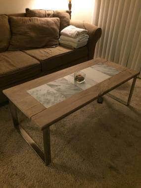 Custom coffee table made from hardwood and marble with Stainless steel legs by SoCal Carpentry in San Diego Ca
