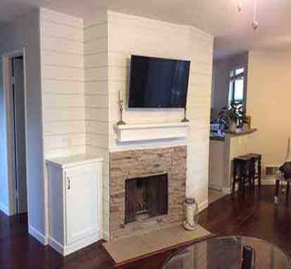 Entertainment center built above fire place in SoCal home